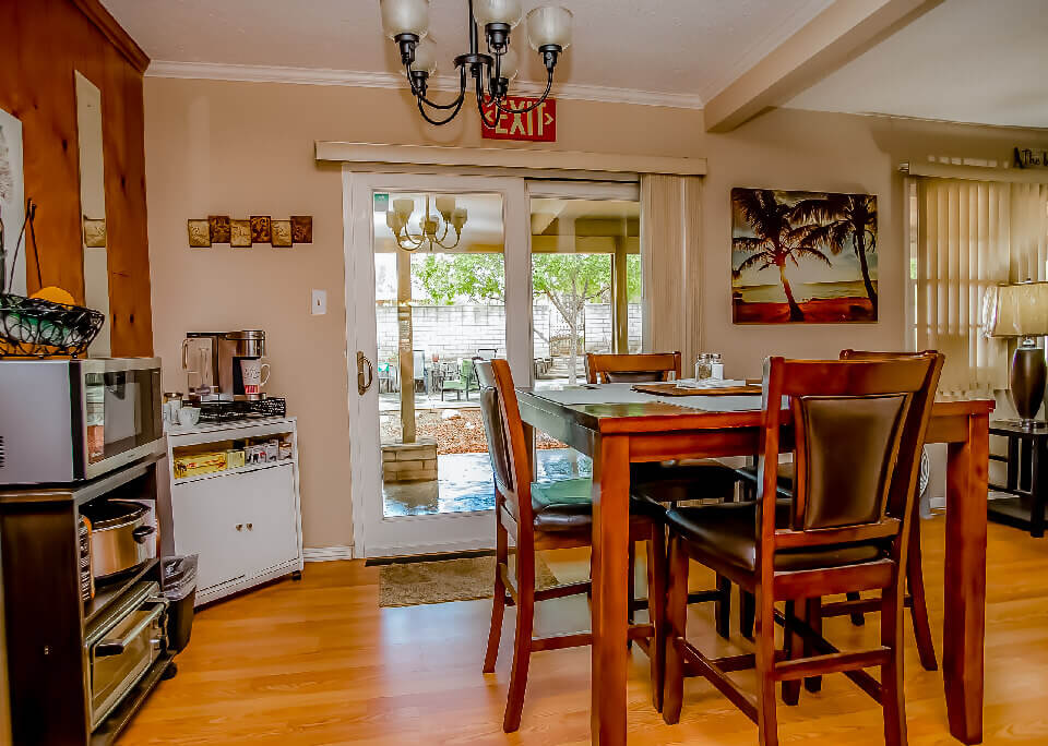 Dining area with high table, chairs, and small appliances