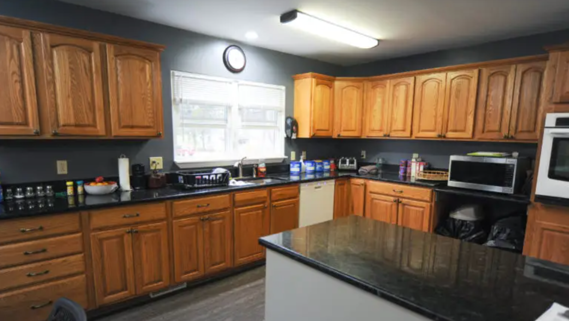 Community kitchen with wood cabinets and central island.