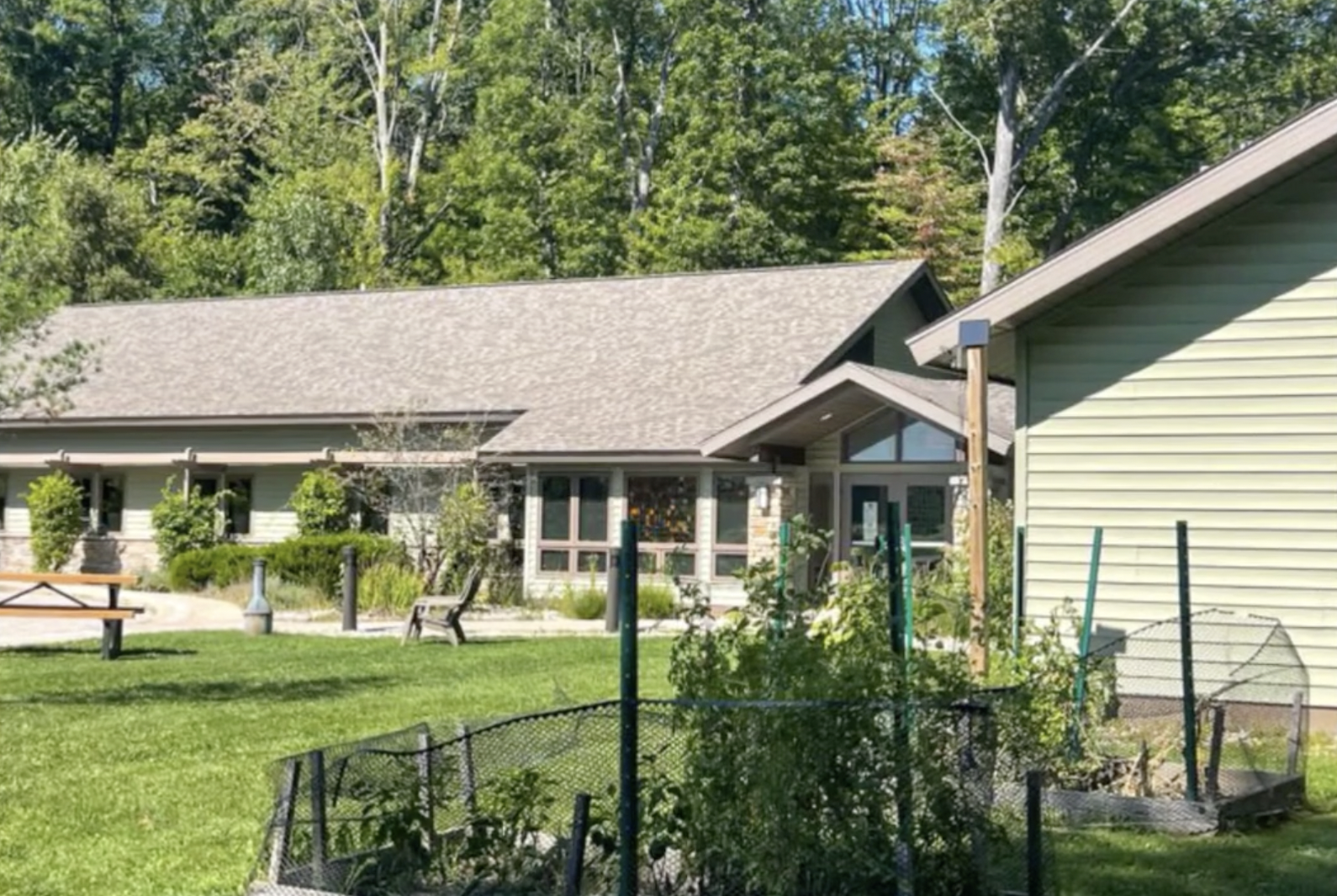 Small garden plot near the facility with plants and fencing