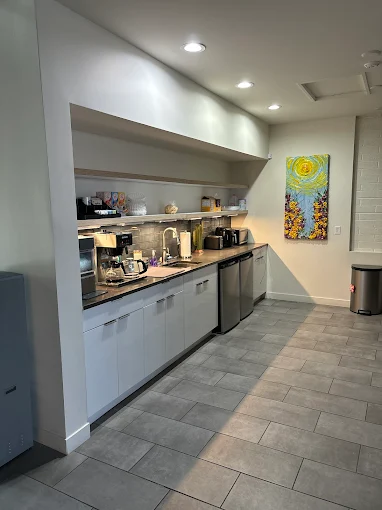 Pantry with coffee setup and fridge units