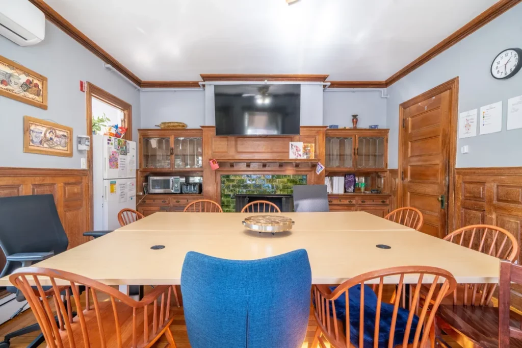 Communal dining room with large table and seating