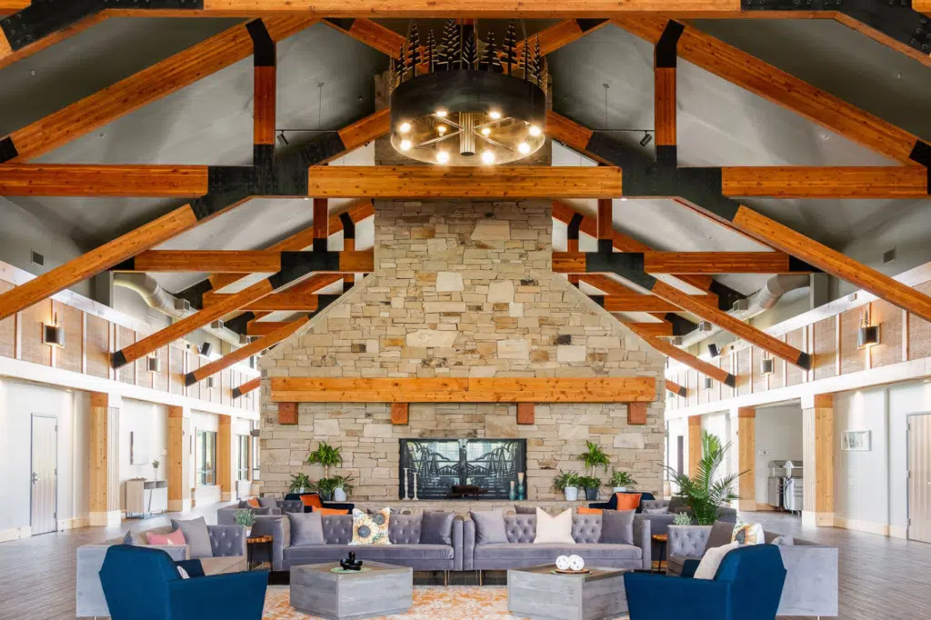 Spacious lodge-style living area with stone fireplace and wood beam ceiling.