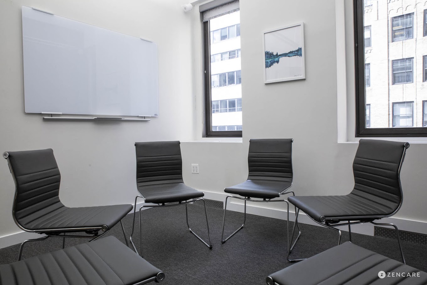 Group therapy room with black chairs.