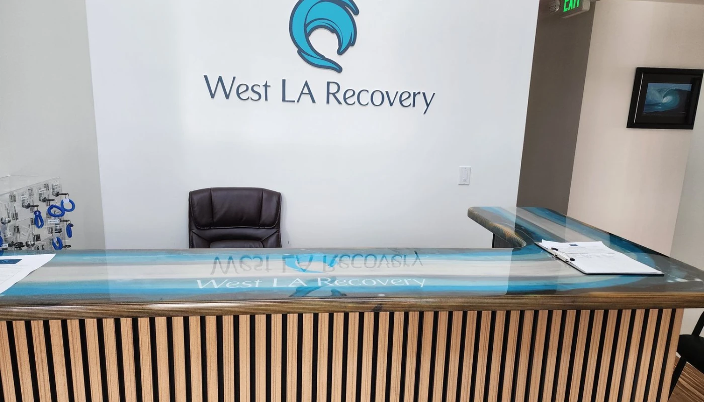 Reception desk with ocean-themed logo on the wall