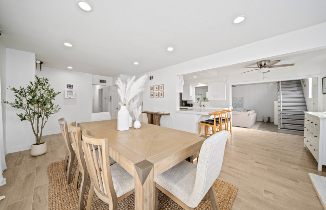Open dining area with wooden table and bright natural light