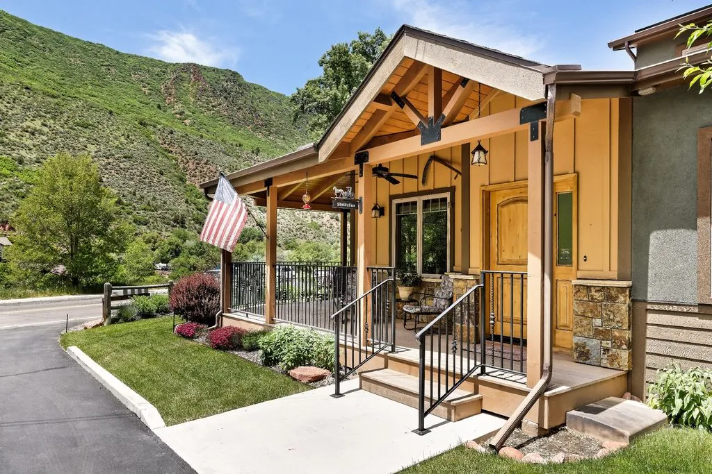 Covered entry with flag and mountain backdrop