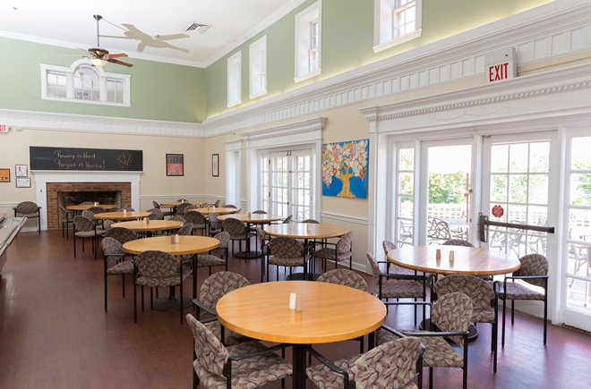Dining hall with tables and seating for residents
