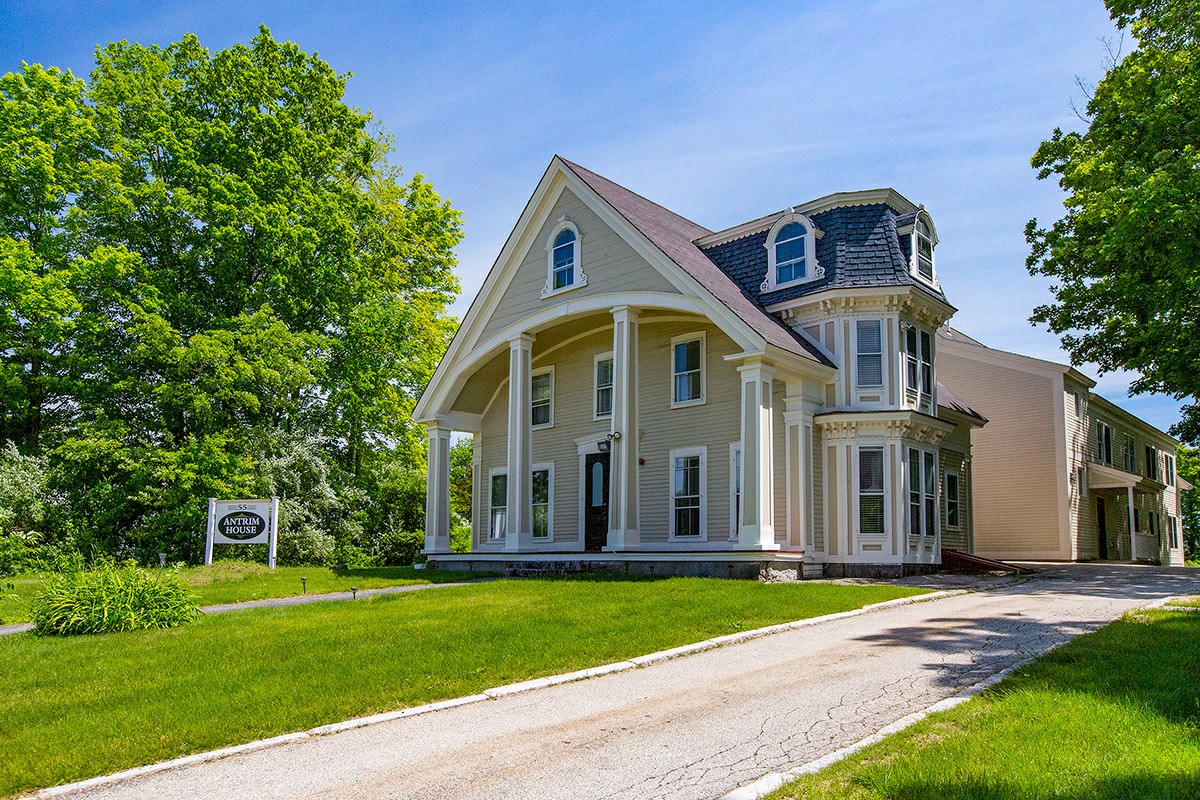 Historic home with columns and manicured lawn