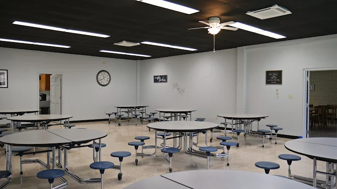 Dining area with round tables and wall clock