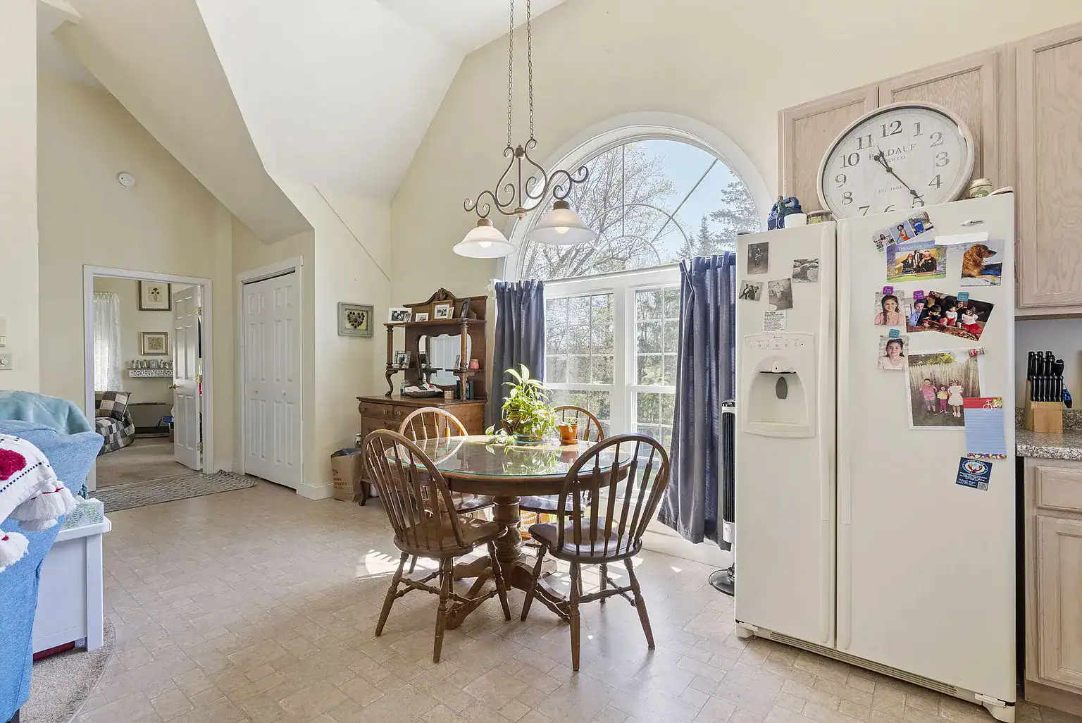 Sunlit dining area with vaulted ceilings adjacent to the residential kitchen at Southern Maine Recovery