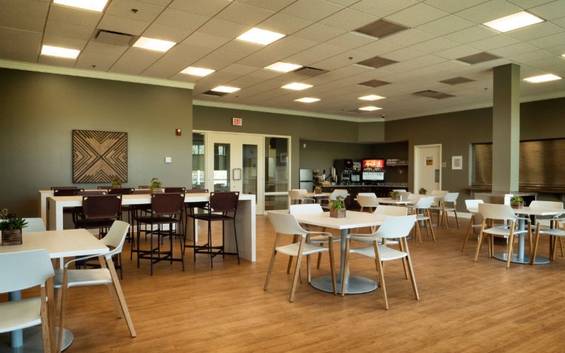 Bright café space with modern tables and beverage station