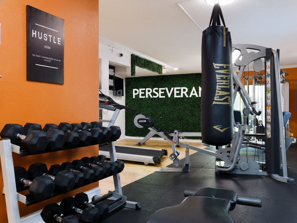 Gym with weights, machines, and a punching bag for exercise.