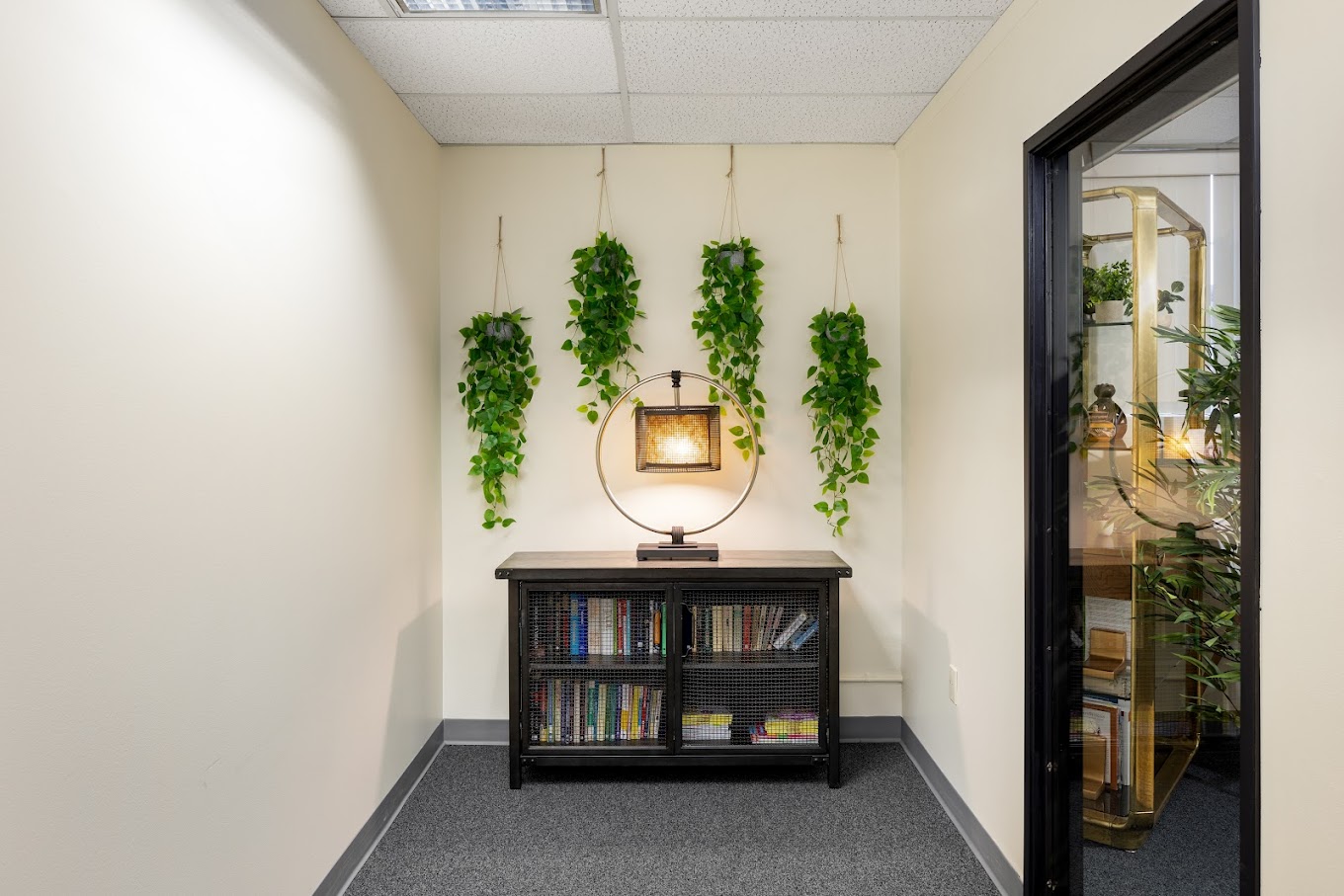 Waiting area with wooden shelf and decor.