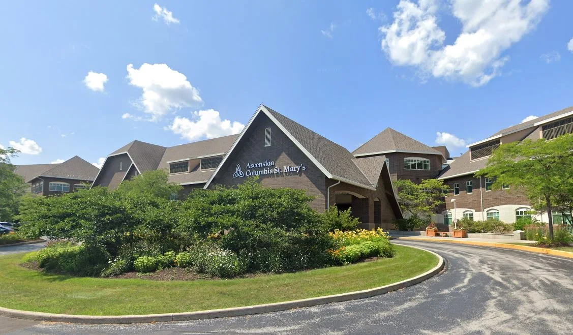 Main hospital entrance with landscaped greenery and signage