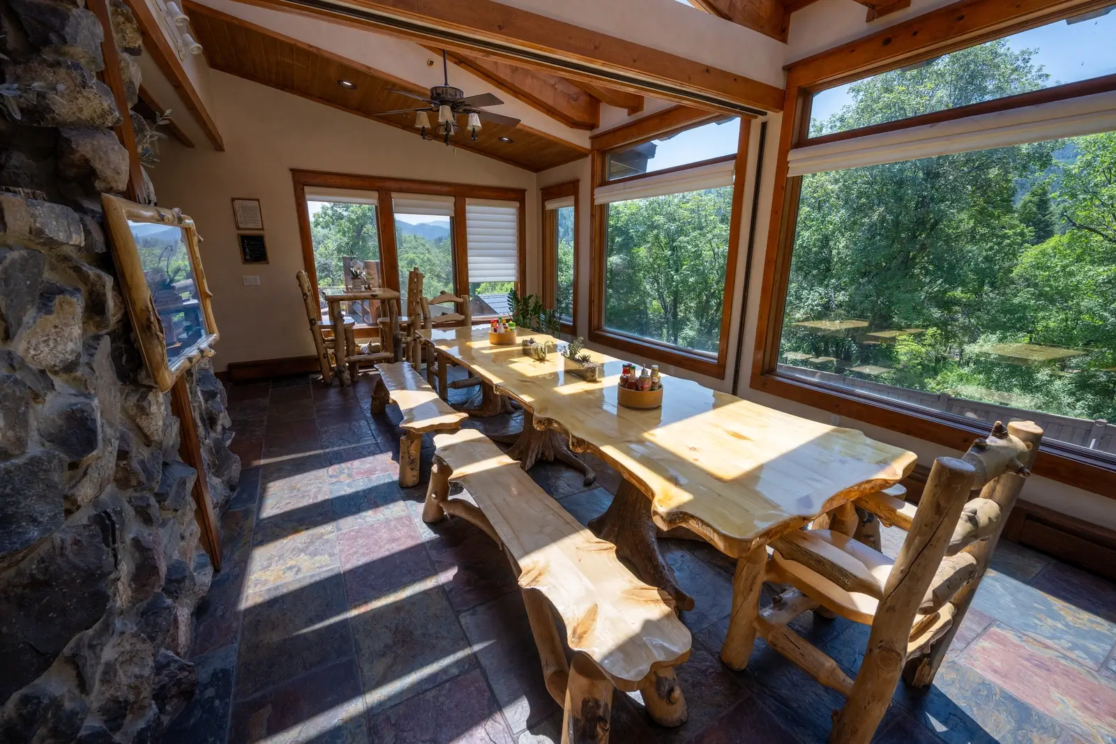 Wooden dining table with mountain views and rustic chairs