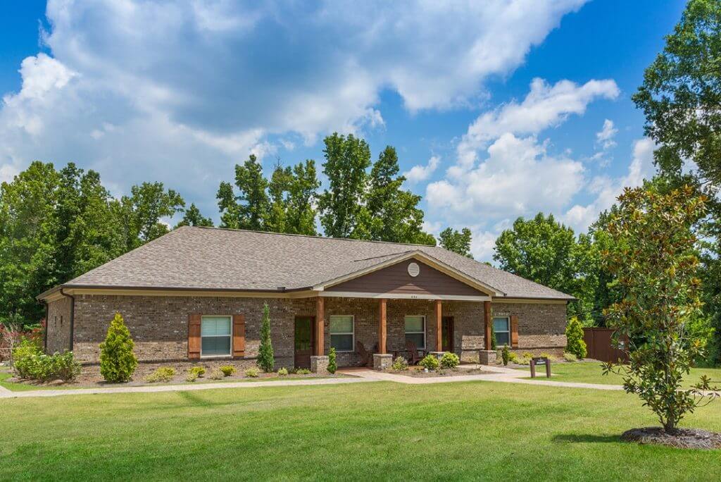 Brick residential building with green lawn