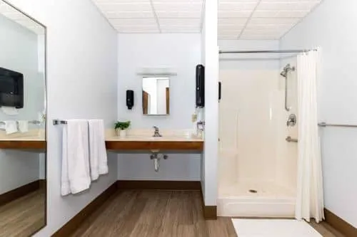 Accessible bathroom with walk-in shower and large mirror