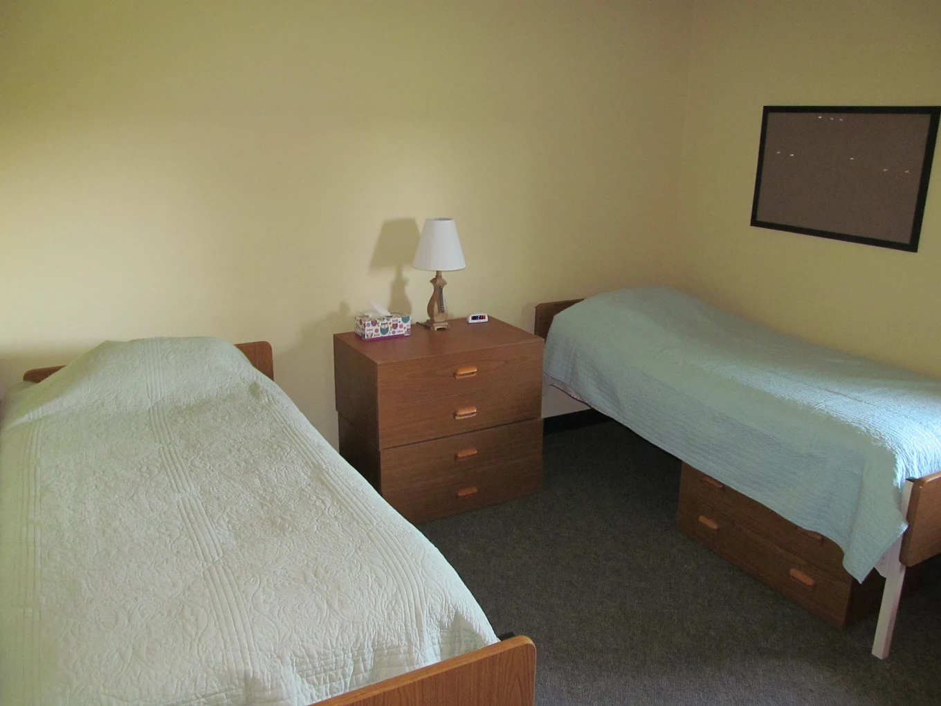 Shared bedroom with two twin beds and bedside storage