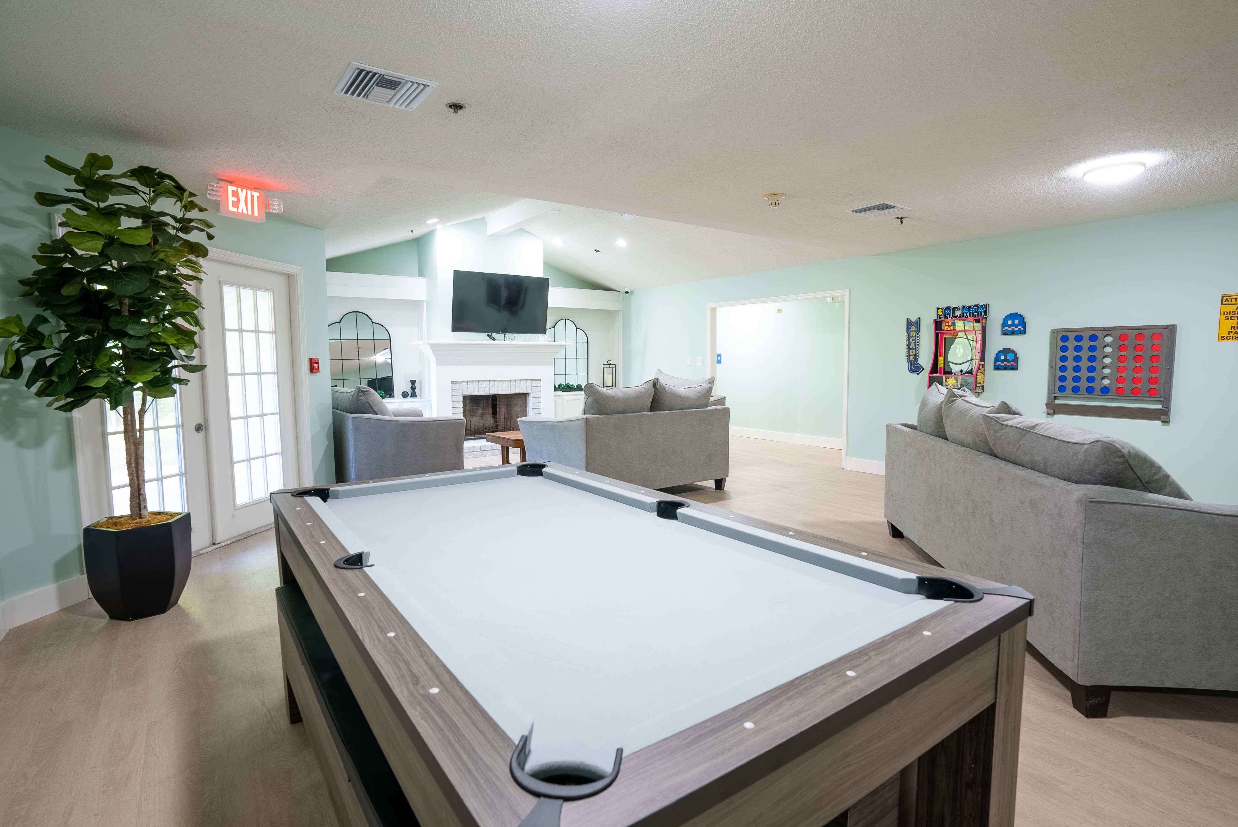 Open game room with pool table and lounge seating.