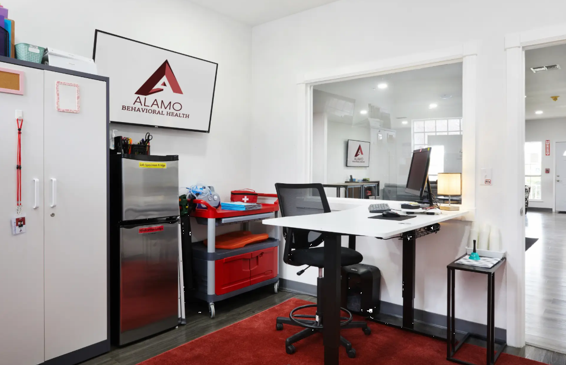Office with desk, fridge, and medical cart