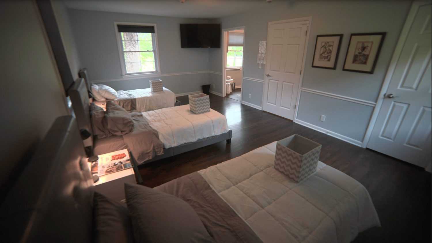 Shared bedroom with three twin beds and TV