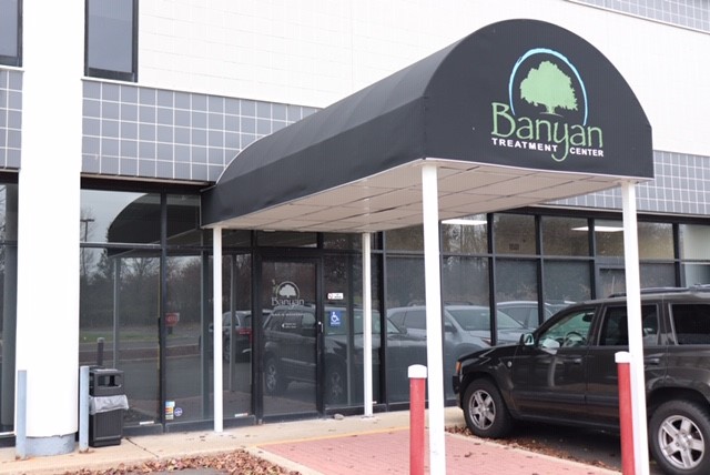  The entrance with signage on a black awning.