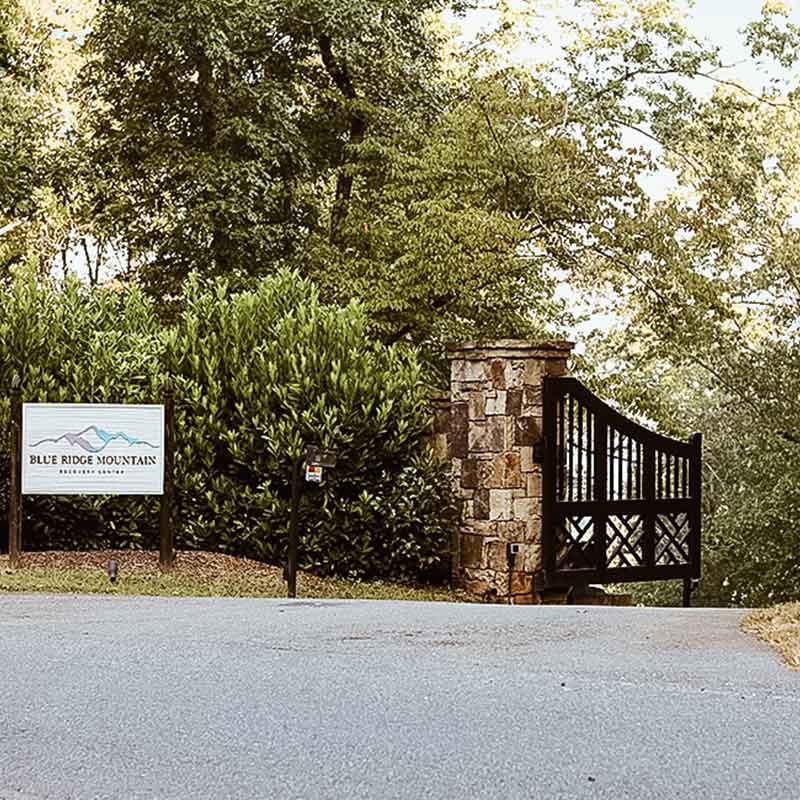 Gated entrance with stone pillars and Blue Ridge Mountain Recovery Center sign