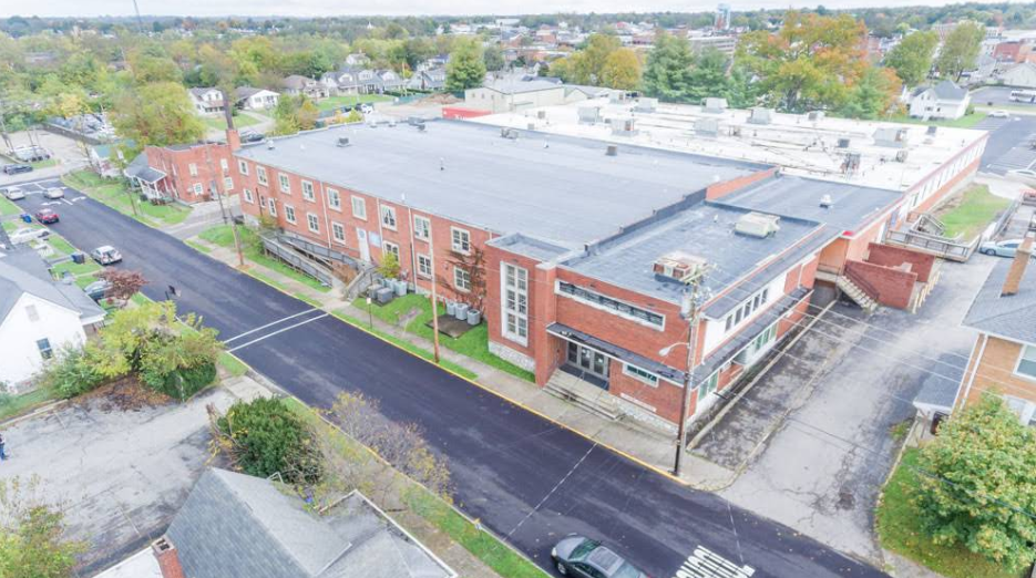 Aerial view of brick treatment center building in town setting