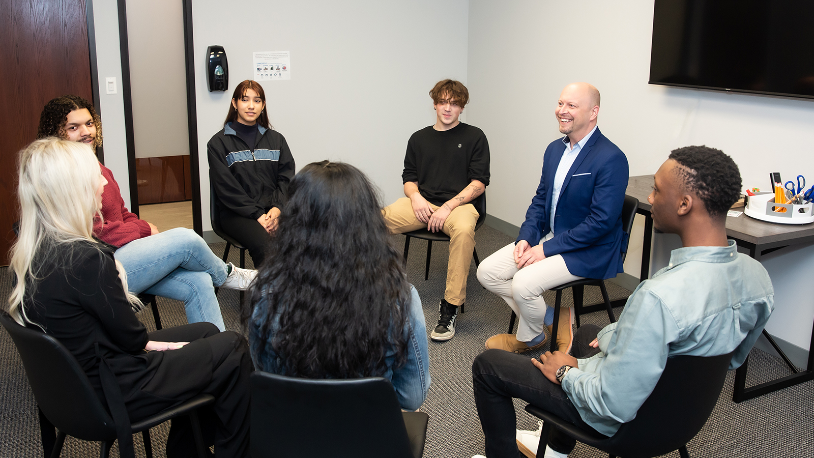 Small group seated in a circle for discussion.