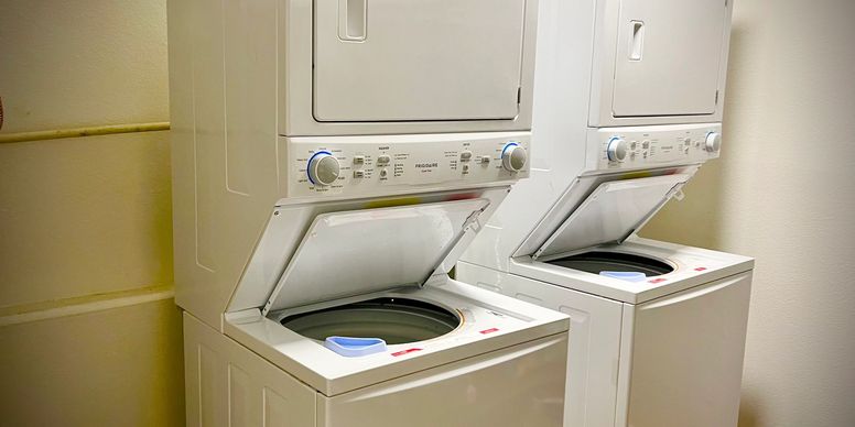 Stacked washers and dryers in laundry room