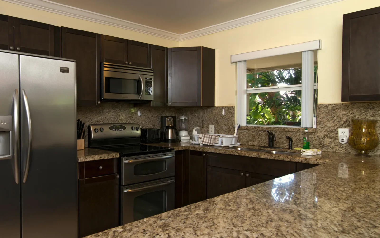 Modern rehab facility kitchen with granite counters and appliances