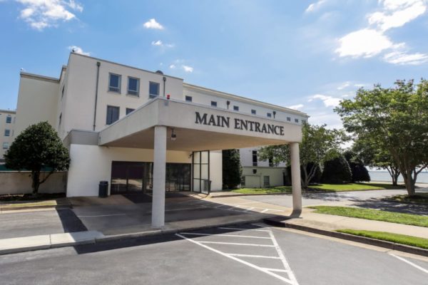 Covered entrance with sign reading "Main Entrance"