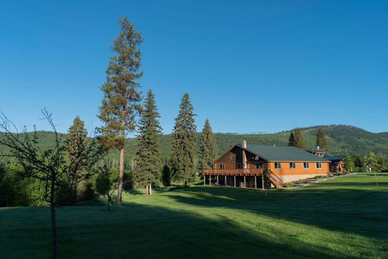 Lodge-style building in open grassy mountain setting