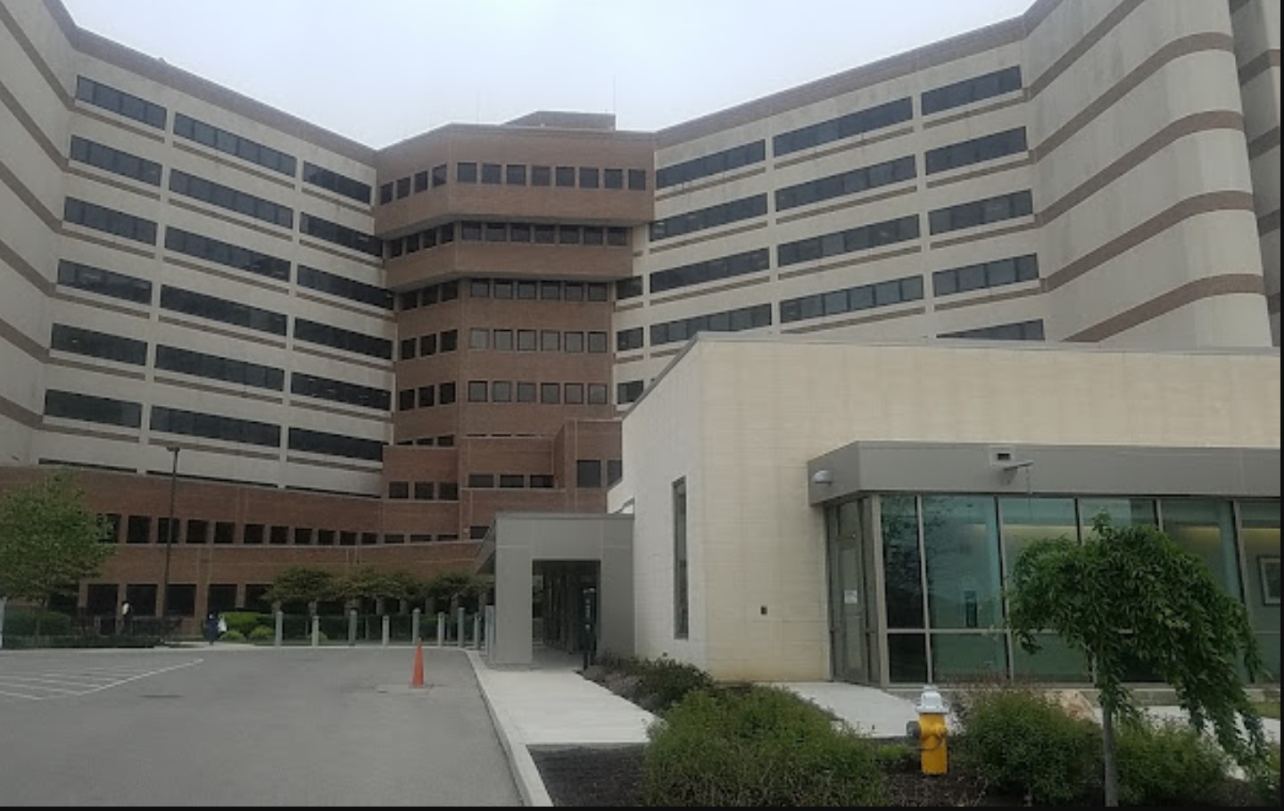 Exterior view of a modern hospital rehab facility with entrance.