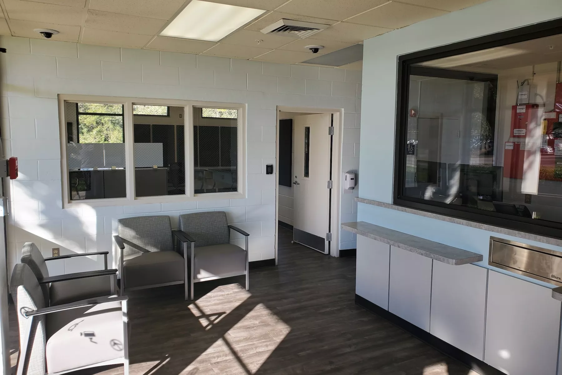 Reception area with seating, service window, and counter