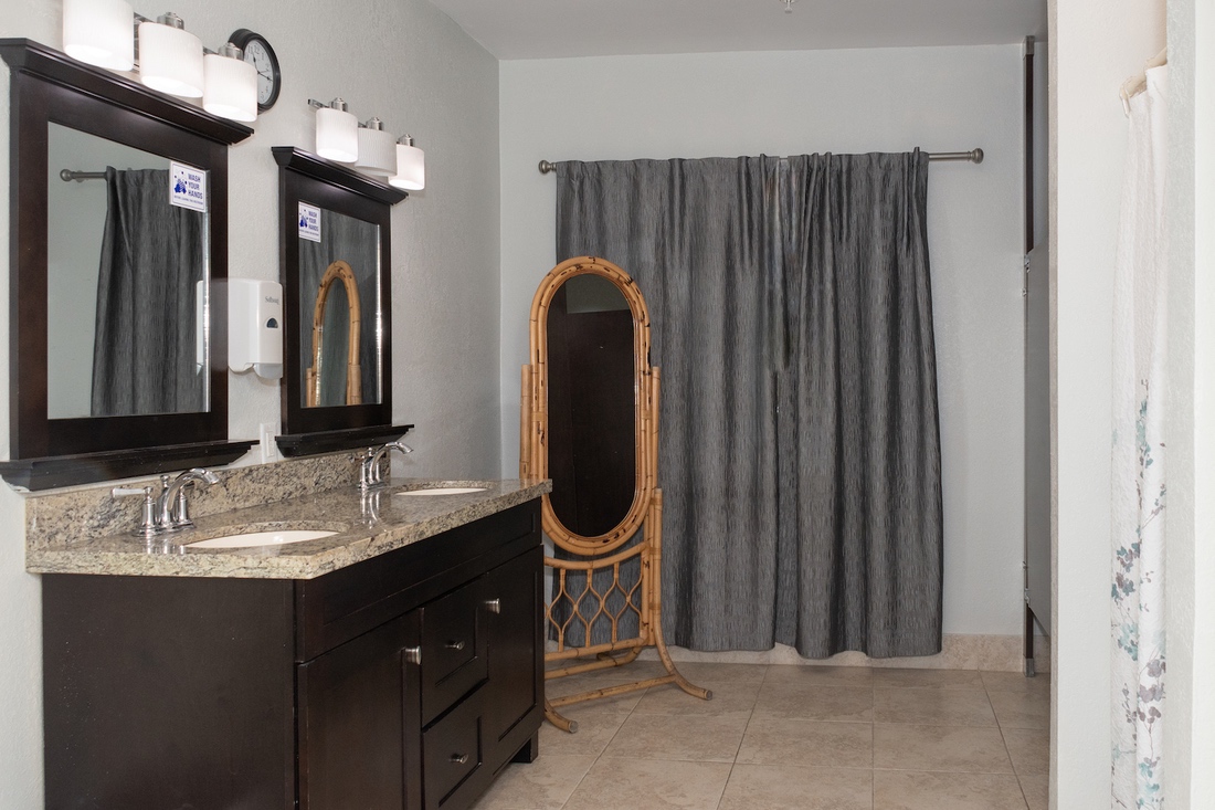 Double-sink vanity with granite countertop and mirrors