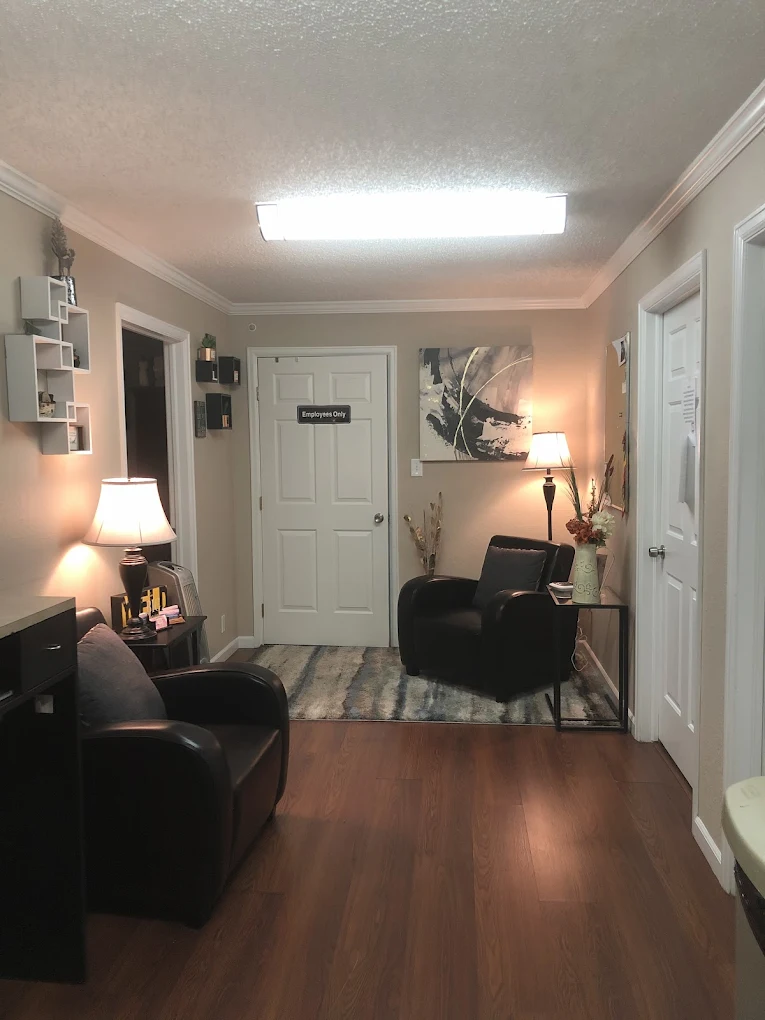 Waiting area with chairs, lamp, and decorative rug