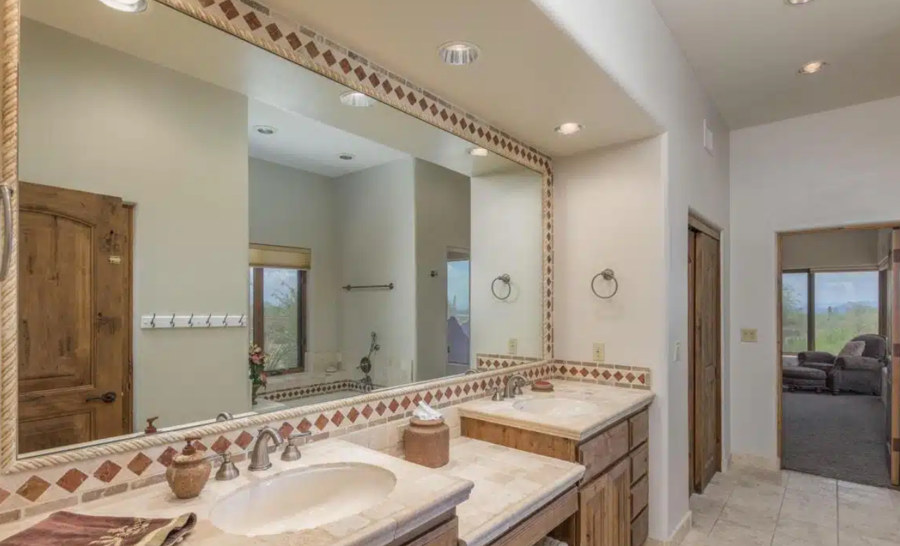 Spacious bathroom with dual sinks and large mirror