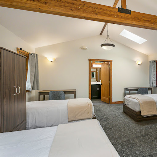 Shared bedroom with twin beds and a desk.