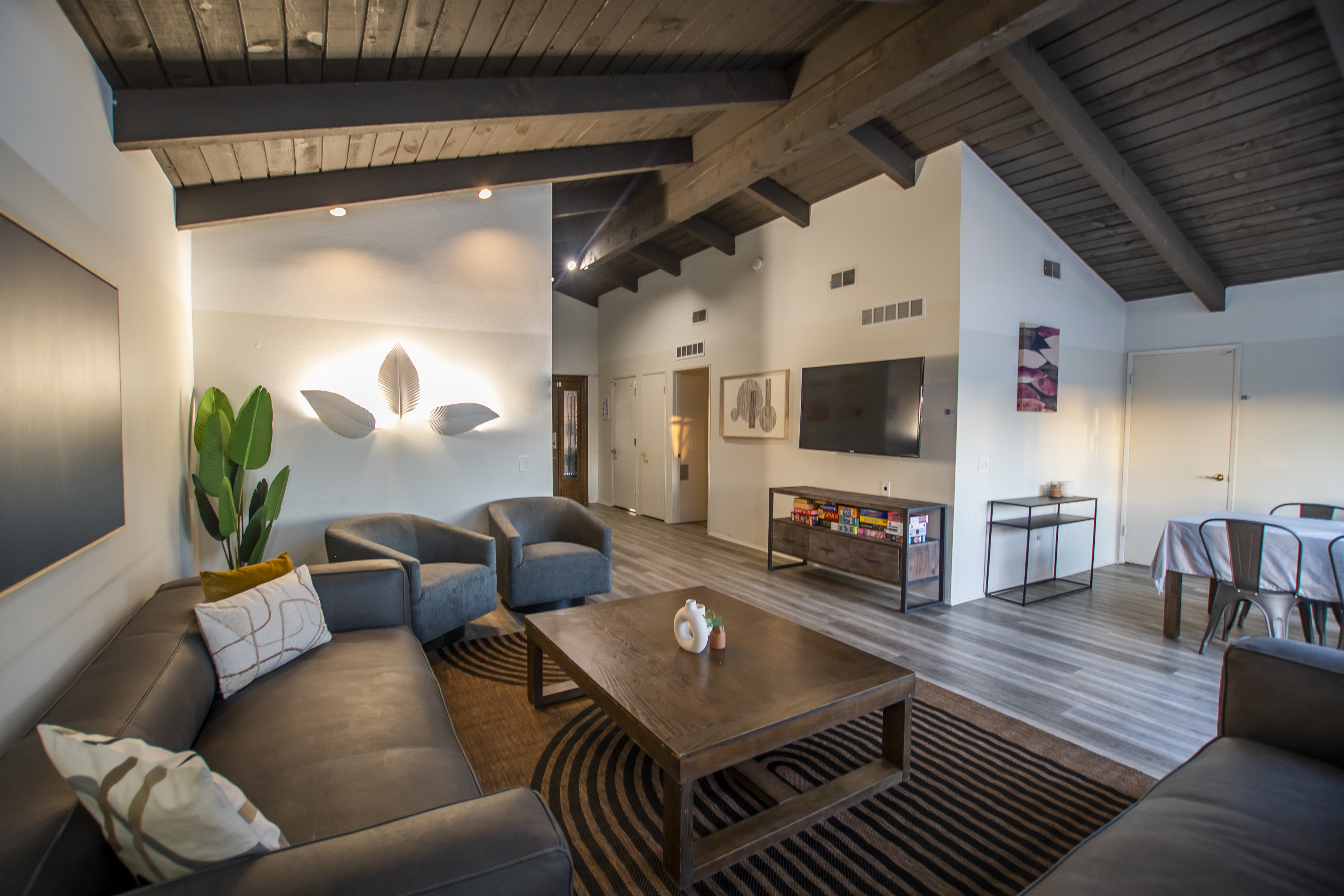 Open lounge with TV, board games, and dining table