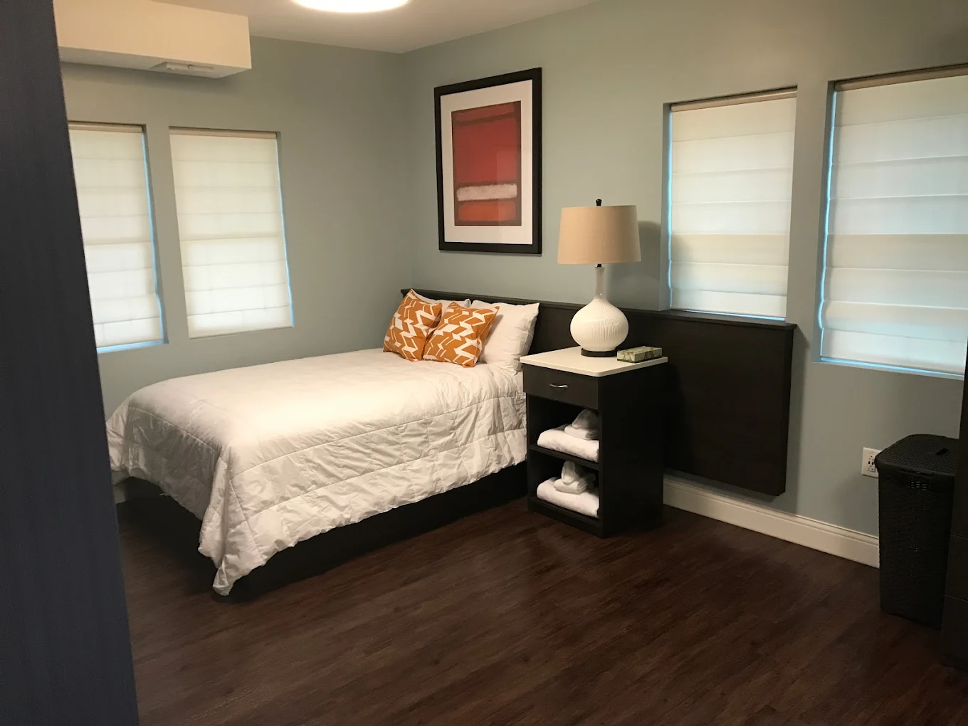Bedroom with full bed, nightstand, and soft lighting