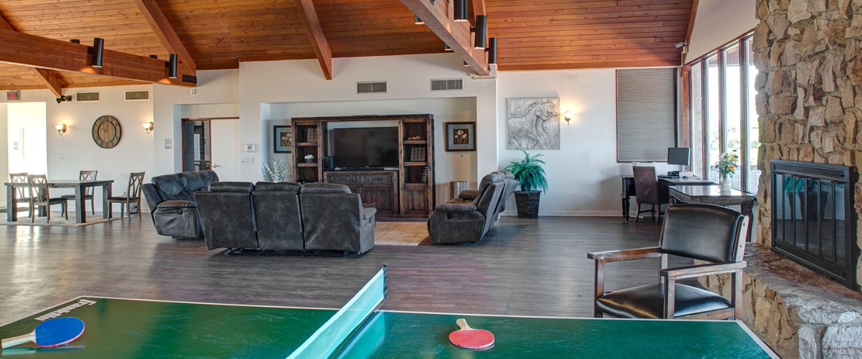 Large community lounge featuring fireplace, seating, and ping pong table at The Ranch Pennsylvania