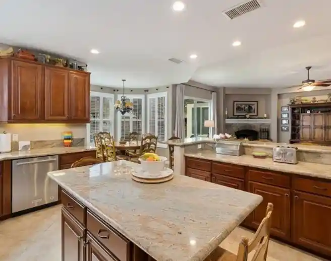 Spacious kitchen with island and open dining area.