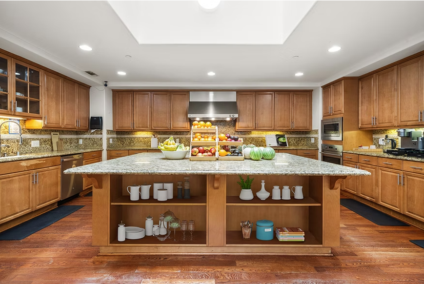 Large kitchen with granite island and wooden cabinetry