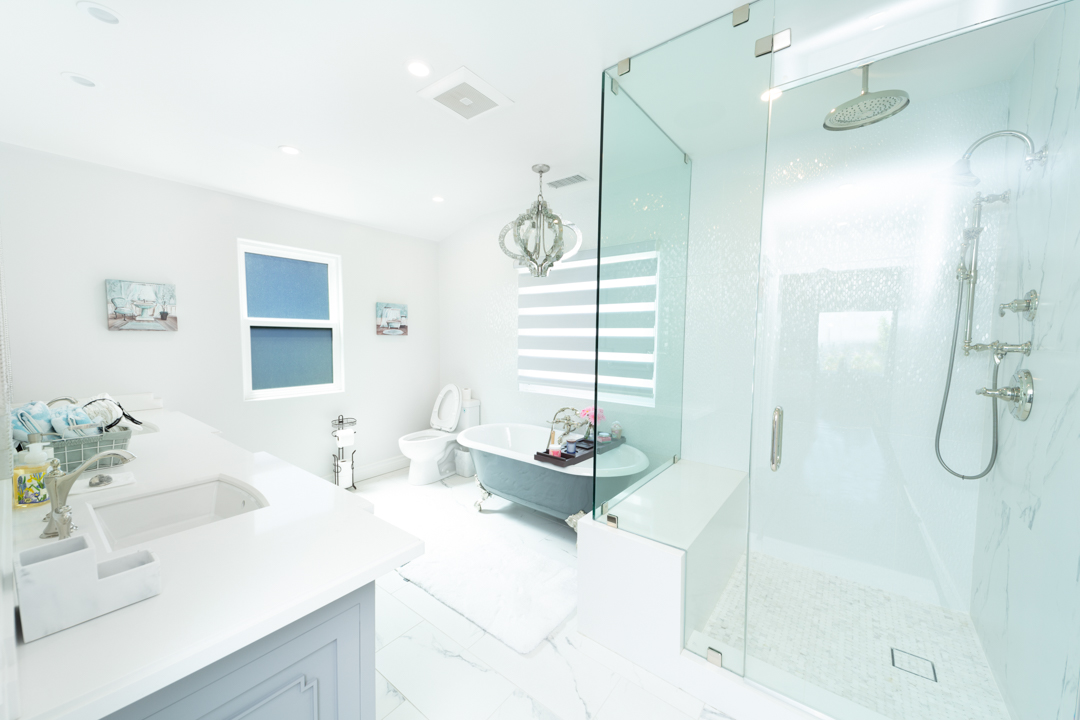 Modern white bathroom with glass shower and soaking tub