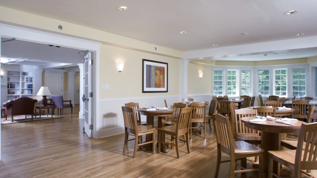 Bright dining room with wooden tables and chairs at Silver Hill Hospital