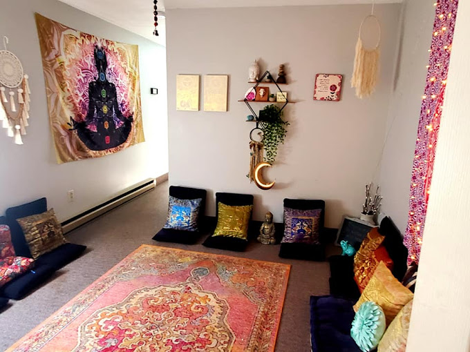 Cozy room with floor seating and spiritual wall decor