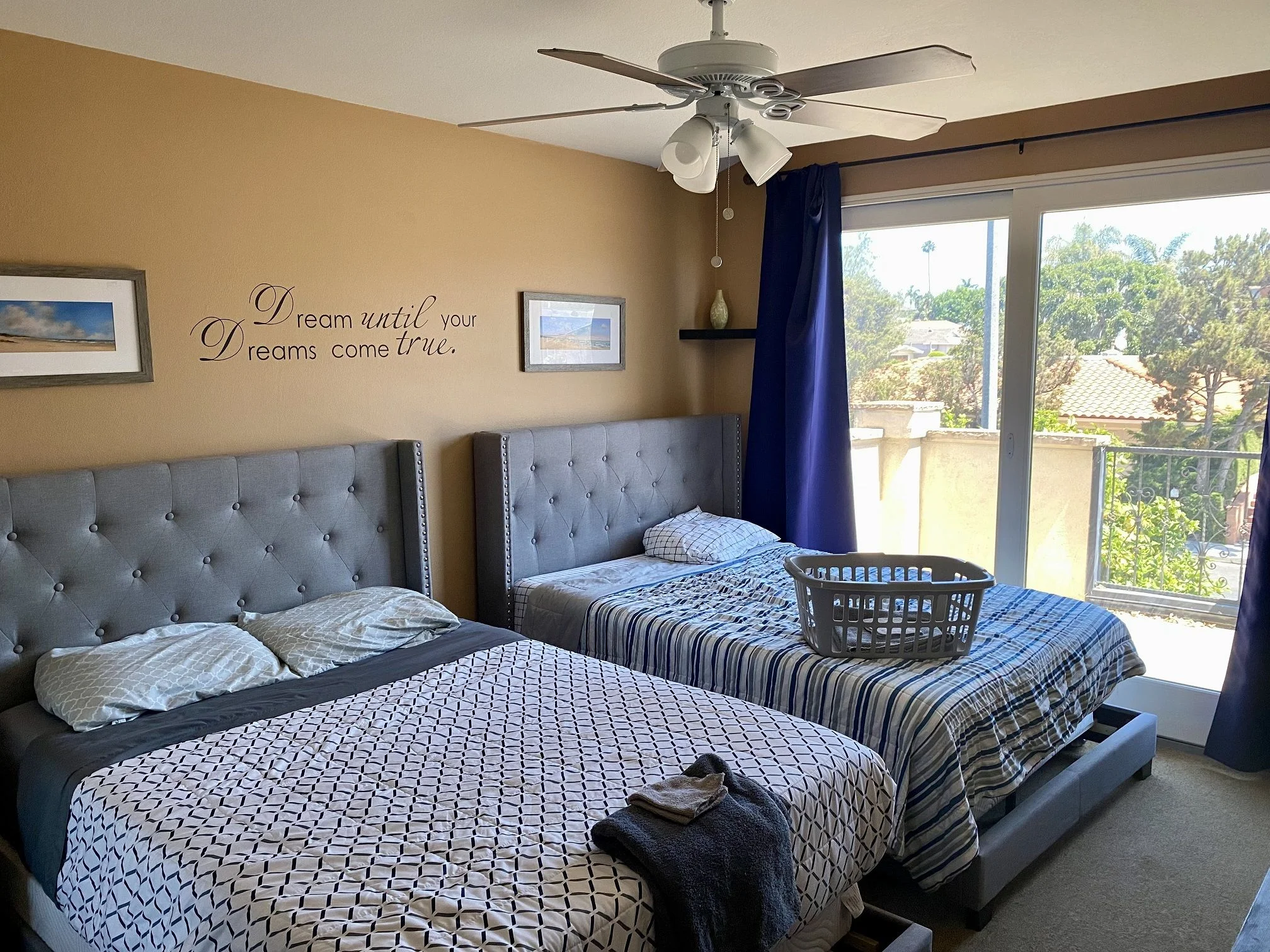 Room with two beds and balcony access