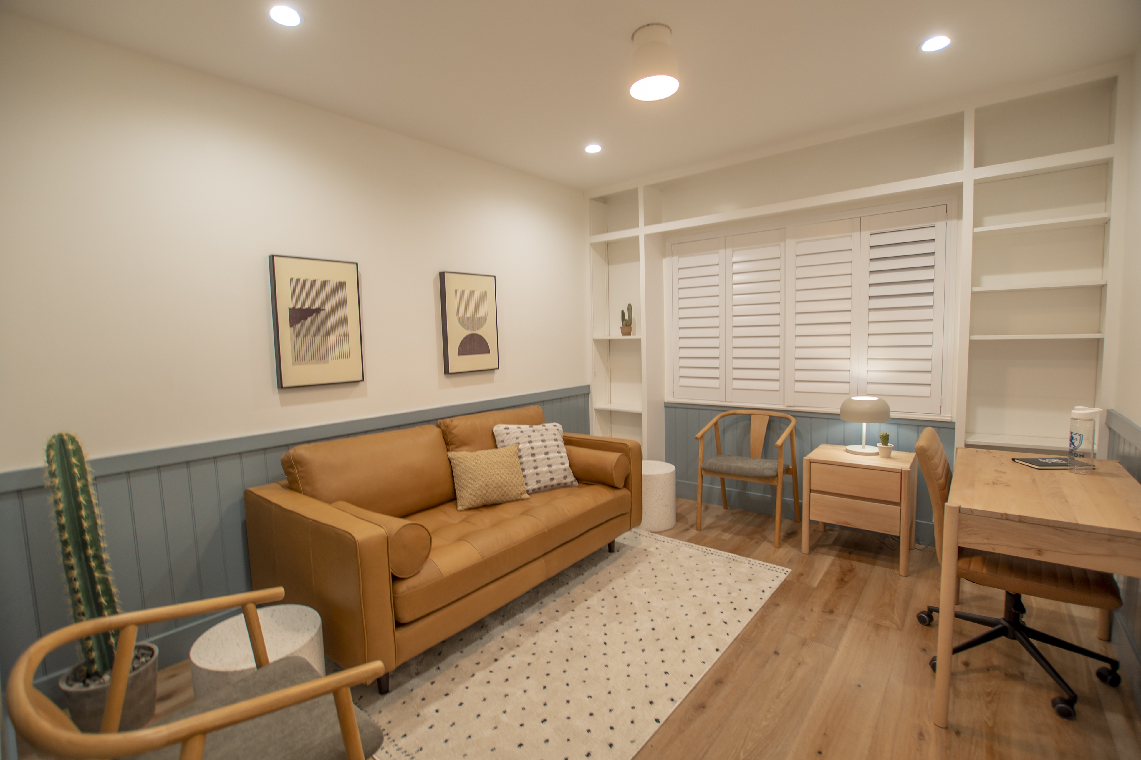 Warm-toned office with sofa, desk, and chairs