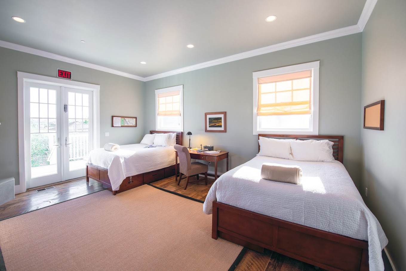 Shared bedroom with two beds and a small desk.